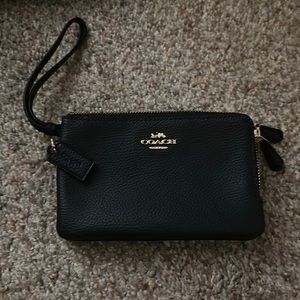 Coach double zip wristlet.  Black with gold zippers.  Bought new, never used.